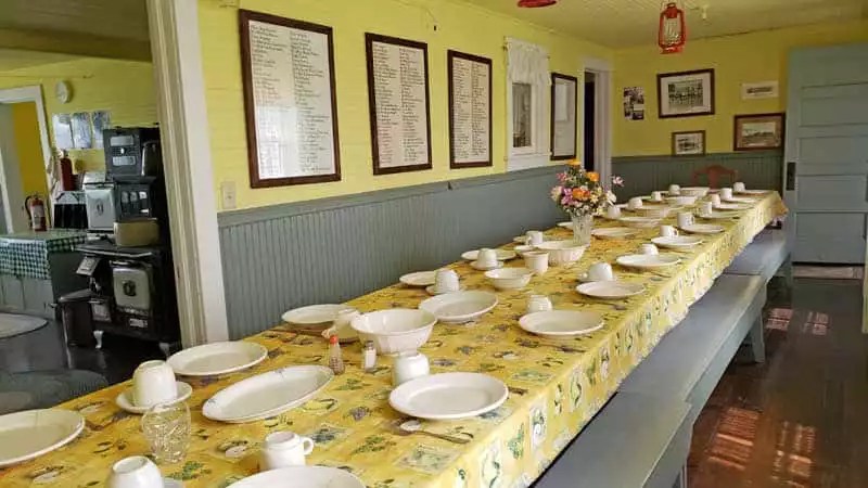 Dining room in historic home set with original dishes and bowls. 