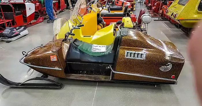 Row of vintage snowmobiles