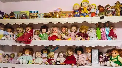 Dozens of dolls on a shelf
