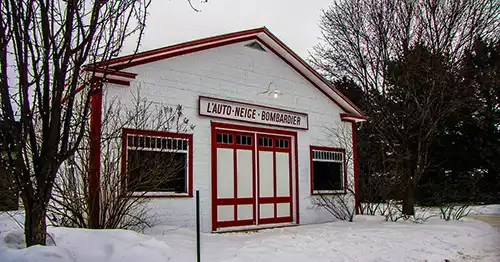 Small white wooden structure with red trim. 
