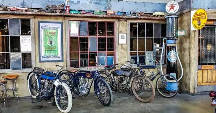 Three Thor motorcycles manufactured between 1901 - 1907, along with a vintage gas pump, vintage toy trucks, and other memorabilia.