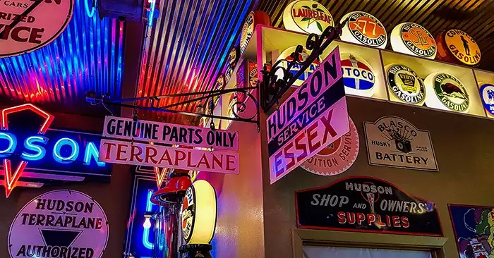 Collectible signs from different fuel station brands and types of parts.