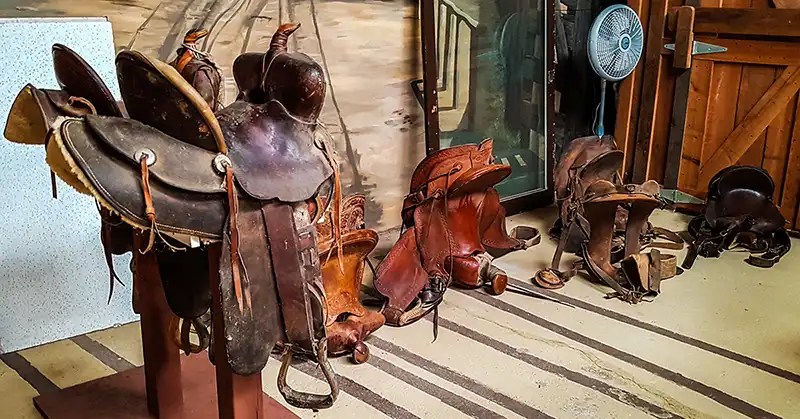 Historic Western saddle on a stand. 