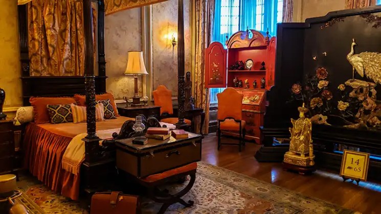 Bedroom suite with orange coverings and accents