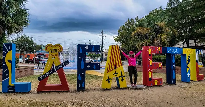 Linda Aksomitis standing in front of the letters spelling out Lafayette. 