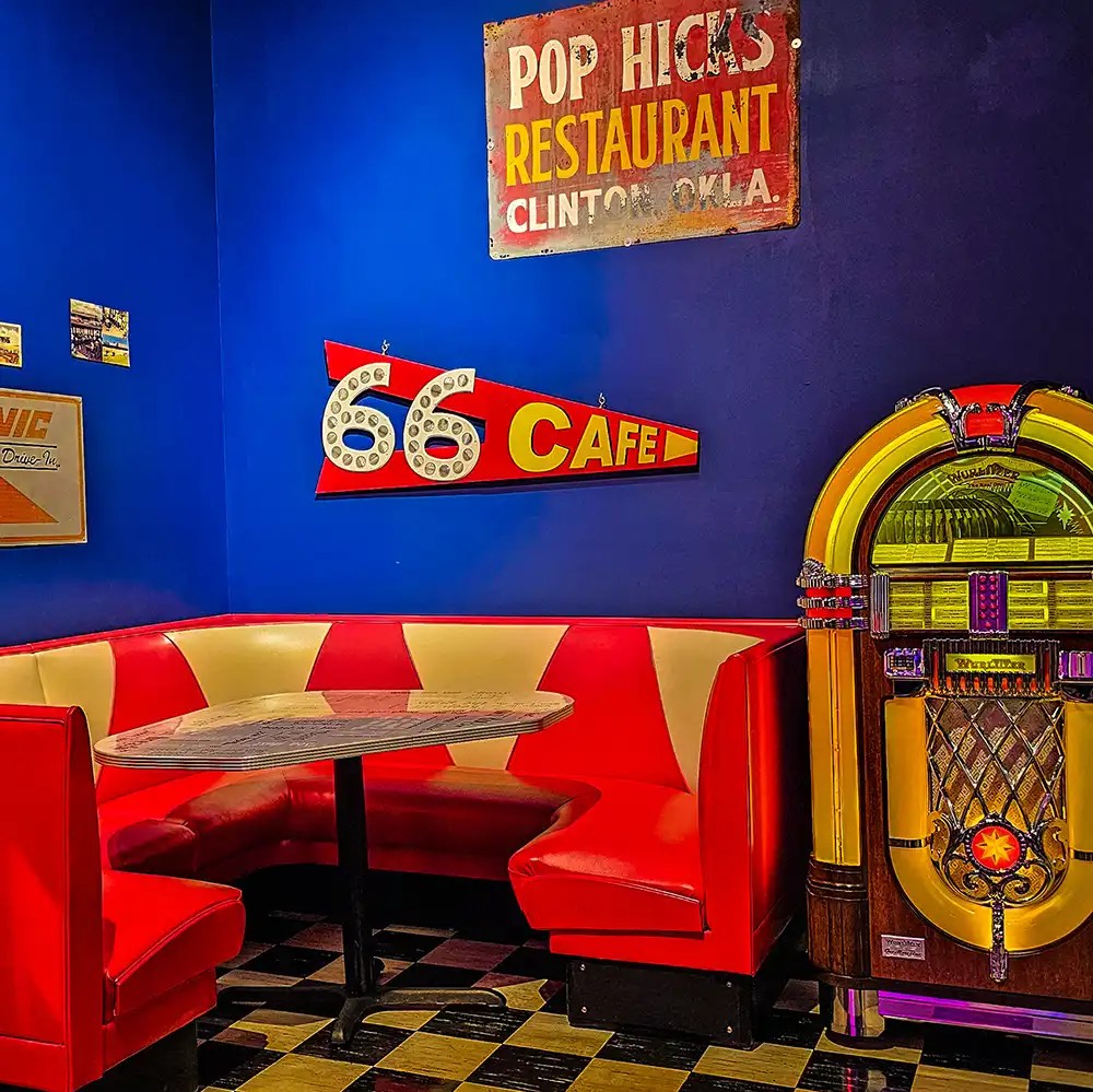 Restaurant red leather corner booth, black and white checkered tiles, and a colorful juke box.  