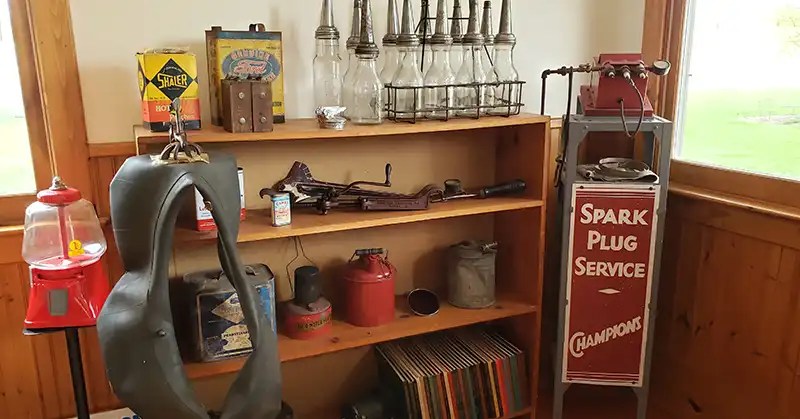tire tube, spark plug display, oil cans, and more that would be inside a gas station.