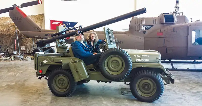 US army jeep with helicopter in the background