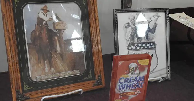 Two framed images and a cream of wheat cereal box.