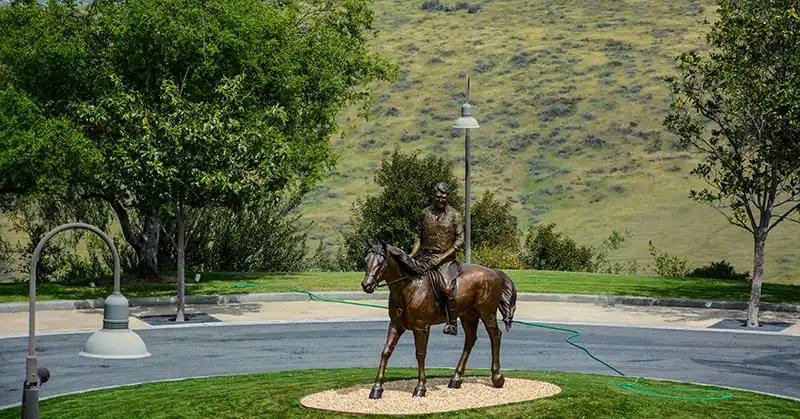 Bronze statue of President Reagan riding El Alemein. 
