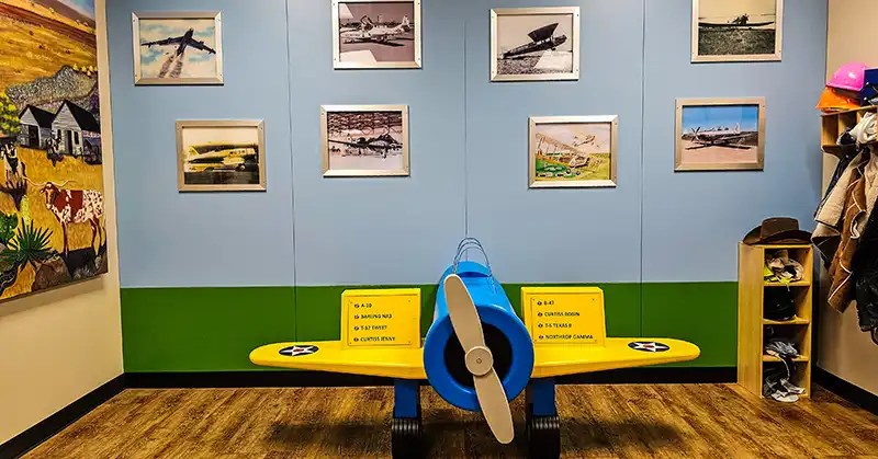 Children's interactive area with educational options and costumes to put on.