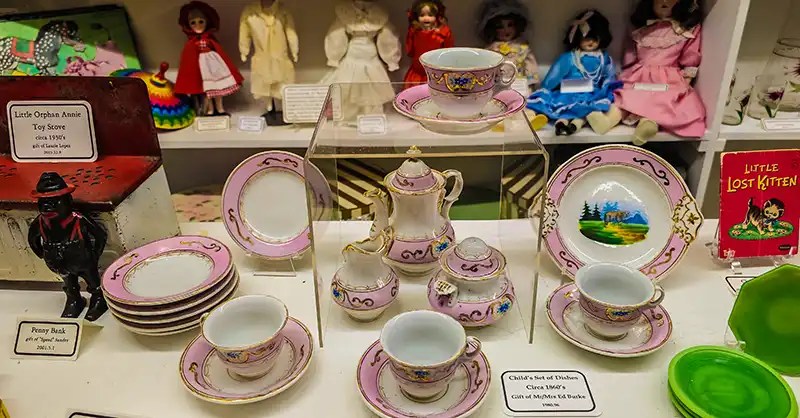 Child's set of dishes, circa 1860s; Little Orphan Annie Toy Stove, circa 1930s; assorted dolls.