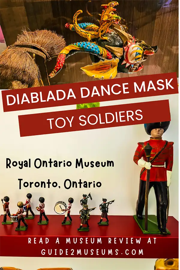 Diablada dance mask and toy soldiers in displays at the Royal Ontario Museum in Toronto, Ontario. 
