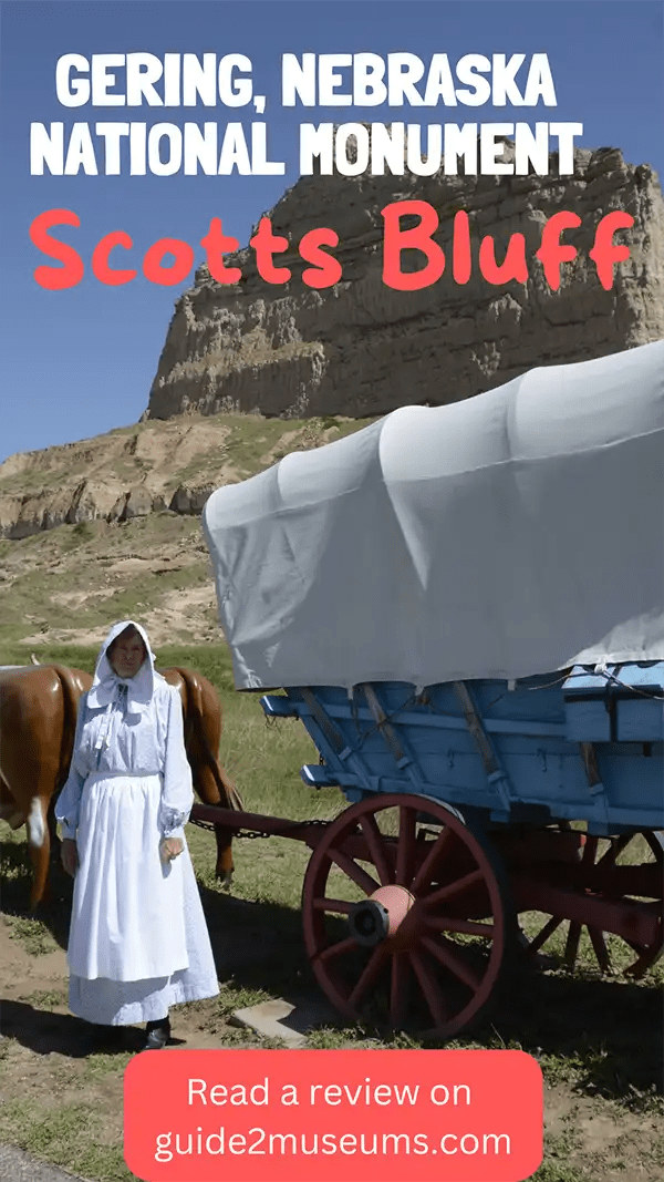 Costumed park ranger standing beside a wagon that would have been on the Oregon Trail | #travel #museums #history #Nebraska