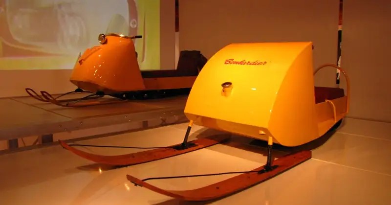 Early single-passenger Bombardier snowmobiles. 