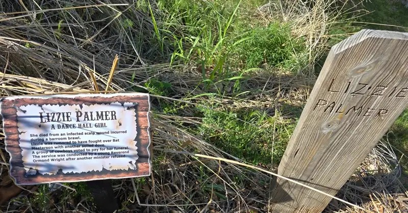 Wooden grave marker for Lizzie Palmer, dance hall girl, in the Boot Hill Museum cemetery