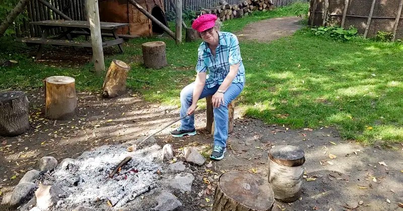 Linda Aksomitis roasting bannock over an open fire. 